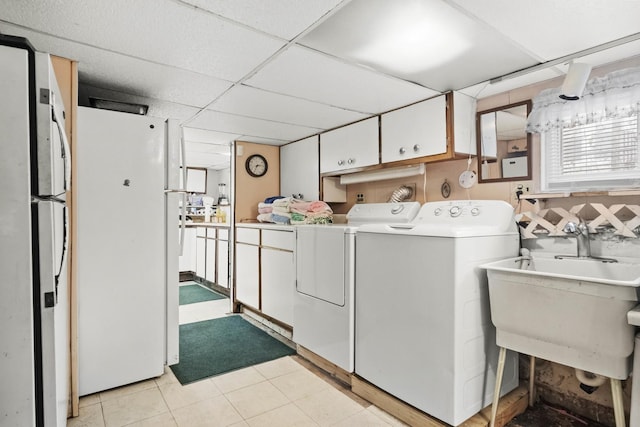 clothes washing area with sink and washer and dryer