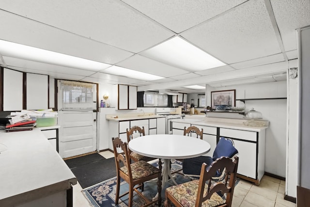 dining room featuring sink and a paneled ceiling