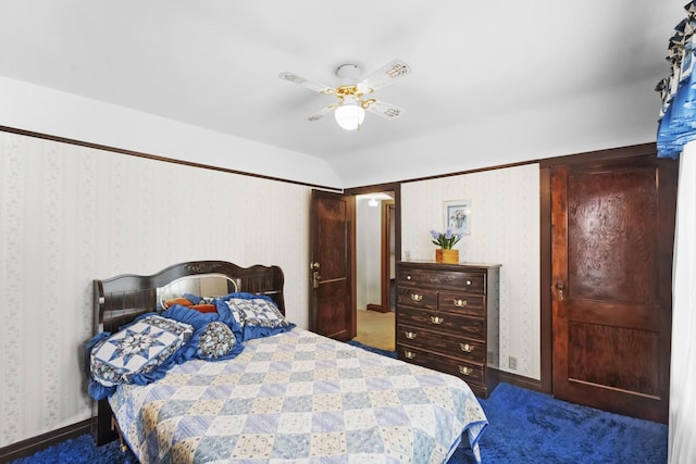 bedroom featuring ceiling fan, lofted ceiling, and dark carpet