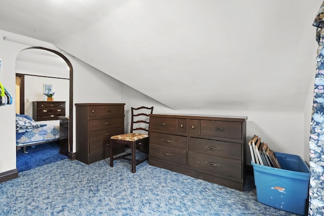 bedroom with vaulted ceiling and carpet