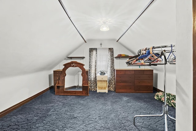 bedroom with vaulted ceiling and dark carpet