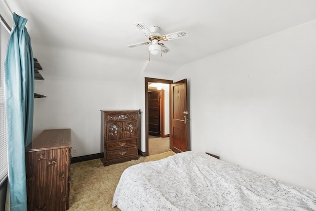 carpeted bedroom featuring lofted ceiling and ceiling fan