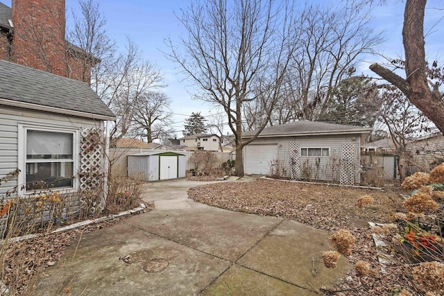 exterior space with a garage and a storage unit