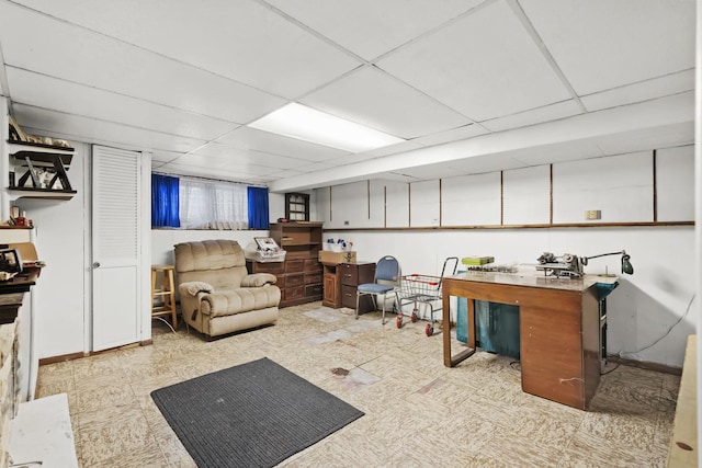 basement featuring a drop ceiling