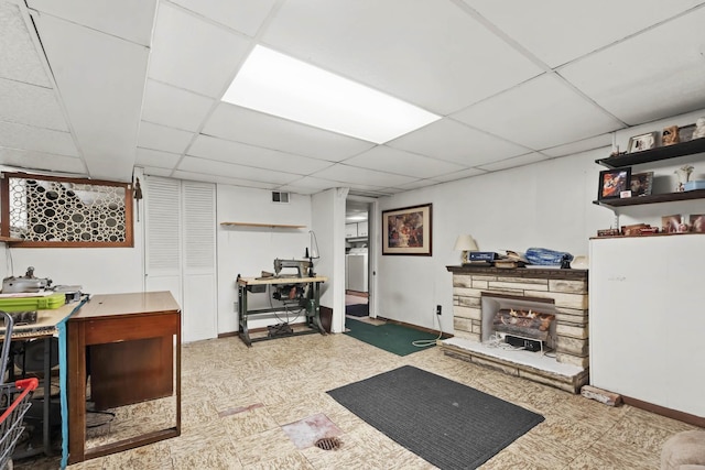 interior space with a paneled ceiling