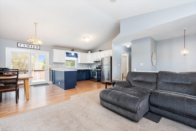 6402 N Shore Ave, Spring Grove, IL 60081 - living area featuring a chandelier, lofted ceiling, and light wood-style floors