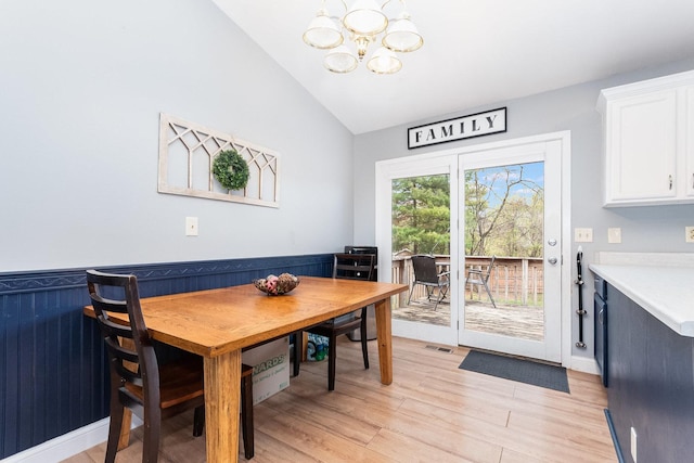 6402 N Shore Ave, Spring Grove, IL 60081 - dining area featuring a chandelier, vaulted ceiling, light wood-type flooring, and baseboards