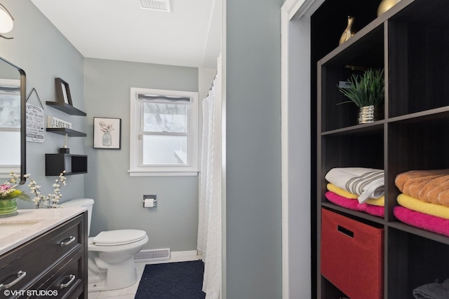 full bath featuring visible vents, toilet, vanity, baseboards, and tile patterned floors