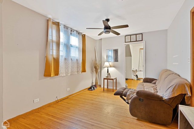 sitting room with ceiling fan and light wood-type flooring