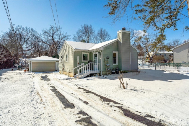 view of front of home with a garage and an outdoor structure