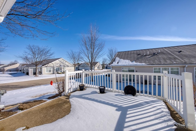 yard covered in snow with a residential view