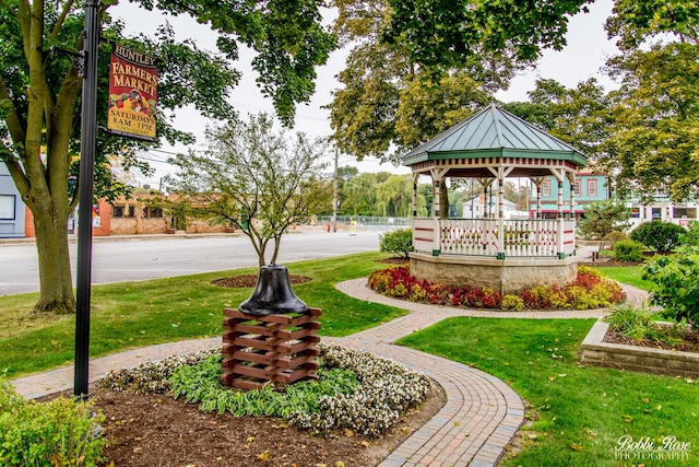 view of property's community with a lawn and a gazebo