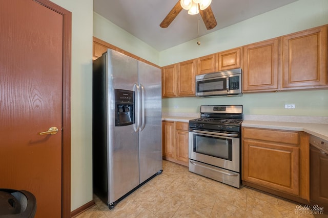 kitchen with brown cabinetry, ceiling fan, stainless steel appliances, and light countertops