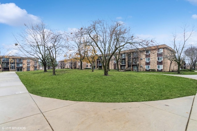 view of property's community with a yard