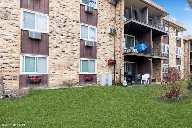 view of building exterior with a wall mounted AC