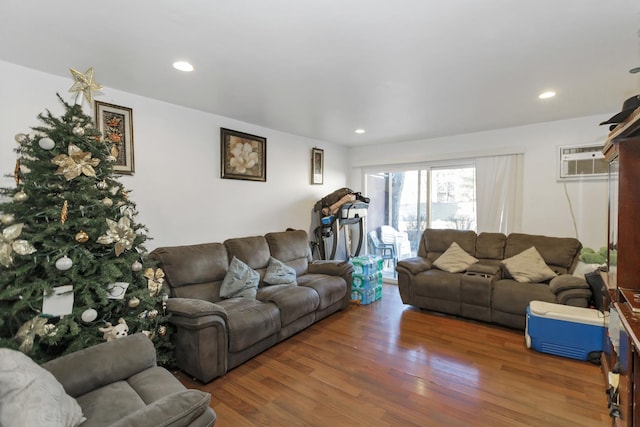 living room with dark hardwood / wood-style floors and an AC wall unit