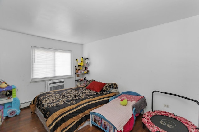 bedroom with dark wood-type flooring, a wall mounted air conditioner, and baseboard heating