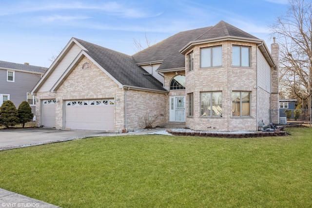 view of front of house with a garage and a front yard