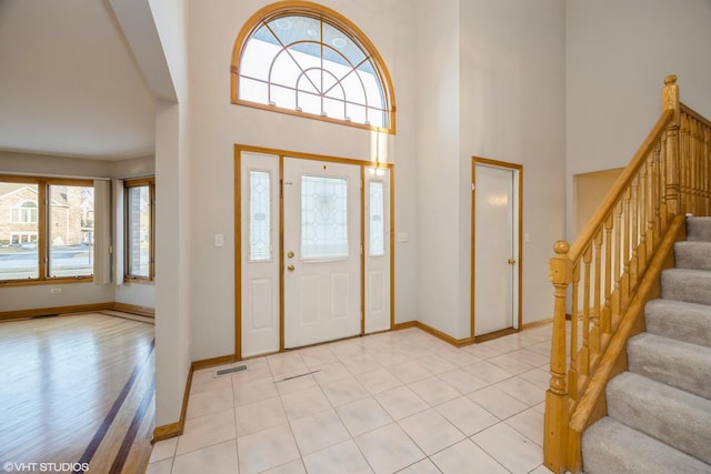 tiled foyer entrance featuring a high ceiling