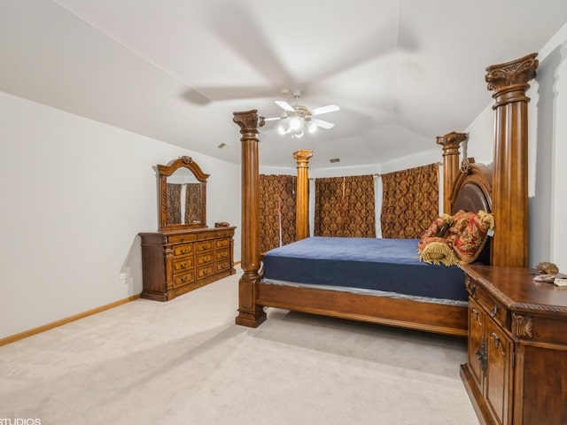 bedroom with baseboards, vaulted ceiling, a ceiling fan, and light colored carpet