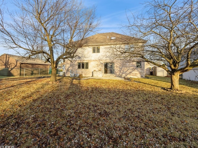rear view of property featuring fence, a lawn, and a patio