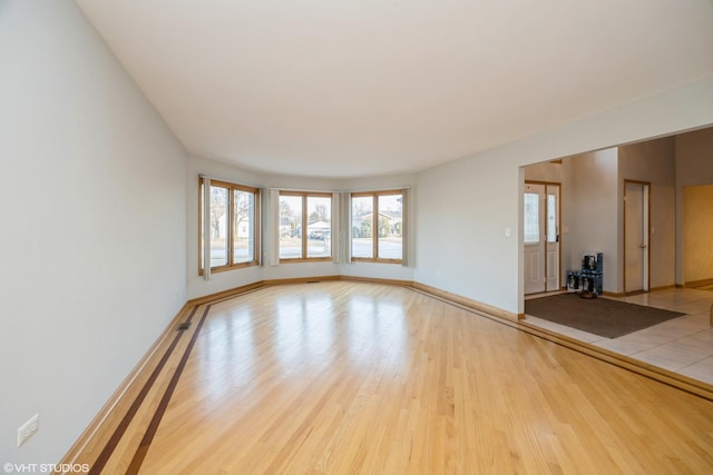 spare room with light hardwood / wood-style floors