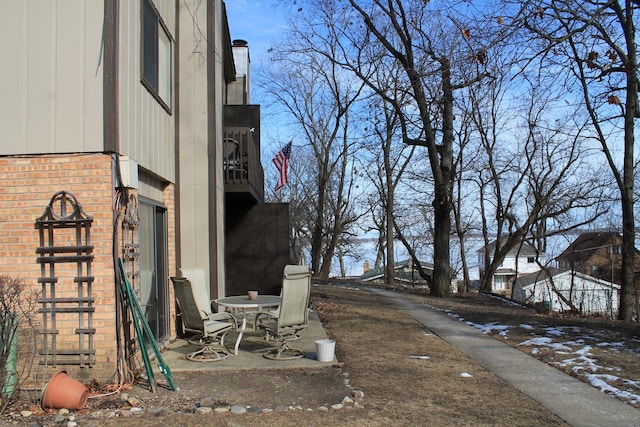 view of side of property featuring brick siding