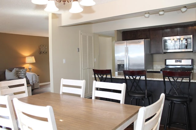 dining space with an inviting chandelier