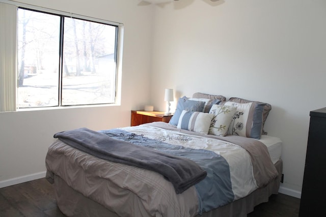 bedroom with dark hardwood / wood-style floors