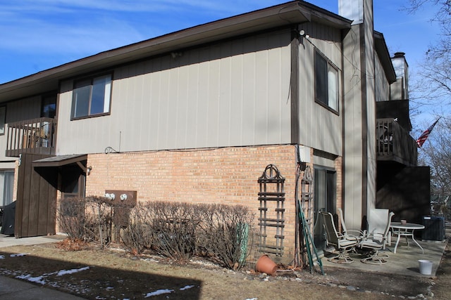 view of side of property with brick siding