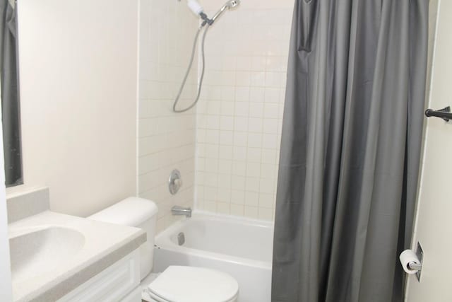 full bathroom with shower / bathtub combination with curtain, vanity, and toilet