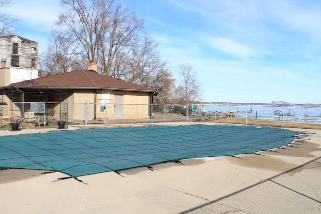 view of pool with a patio area and a water view