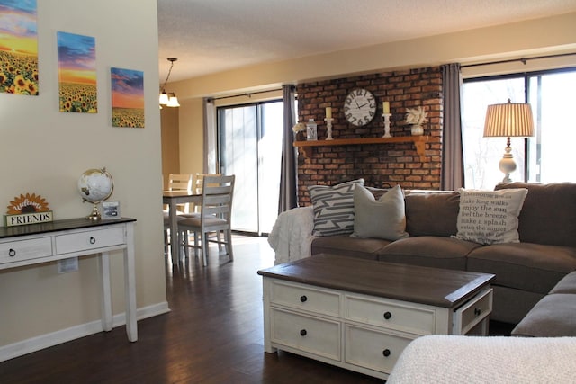 living room with dark hardwood / wood-style floors and a textured ceiling