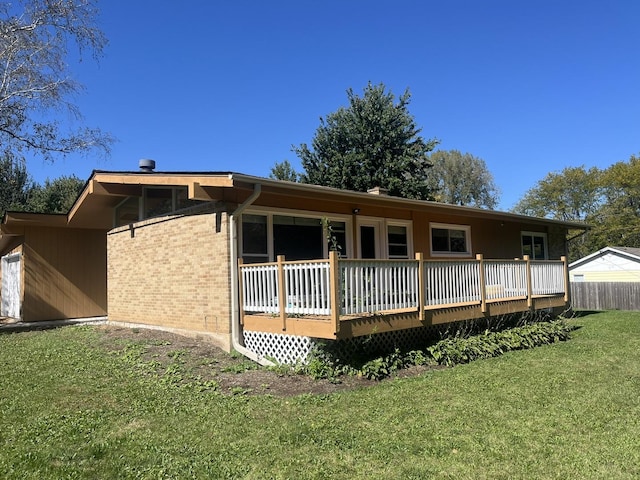 back of property featuring a yard and a deck