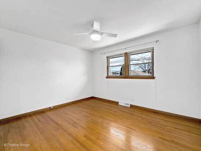 unfurnished room with light wood-style flooring, baseboards, visible vents, and ceiling fan