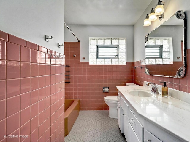 bathroom featuring vanity, tile patterned flooring, shower / tub combination, toilet, and tile walls