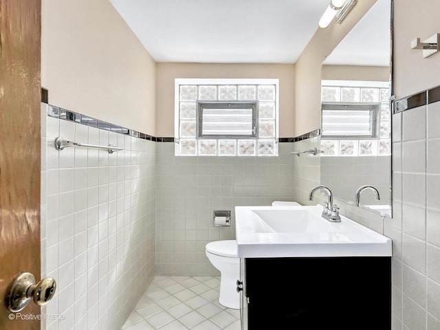 half bathroom featuring tile patterned flooring and tile walls