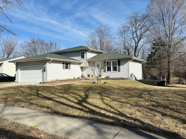 view of front of house with a garage and a front lawn