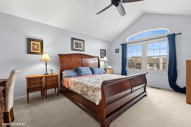 bedroom with ceiling fan, light colored carpet, and vaulted ceiling