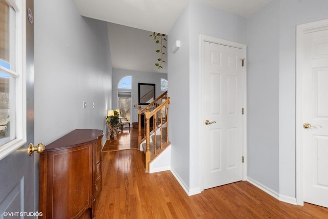 corridor with hardwood / wood-style flooring