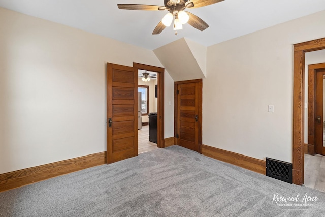 unfurnished bedroom with light colored carpet and ceiling fan