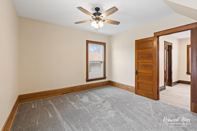 carpeted empty room with ceiling fan