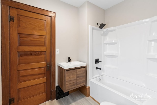 bathroom featuring shower / bathing tub combination, vanity, and hardwood / wood-style floors