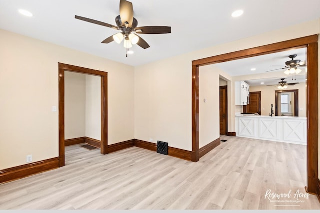 empty room with sink and light wood-type flooring