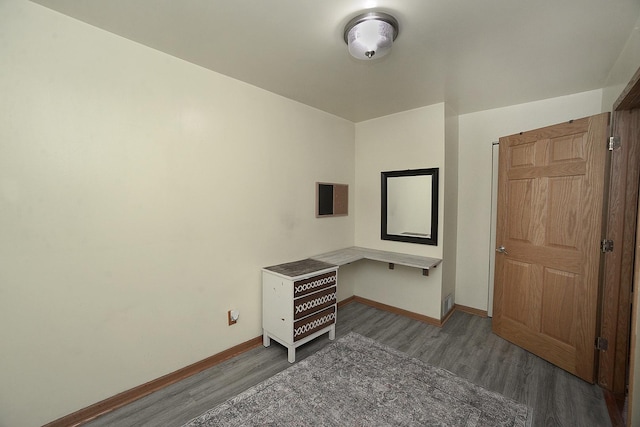 unfurnished bedroom with dark hardwood / wood-style floors