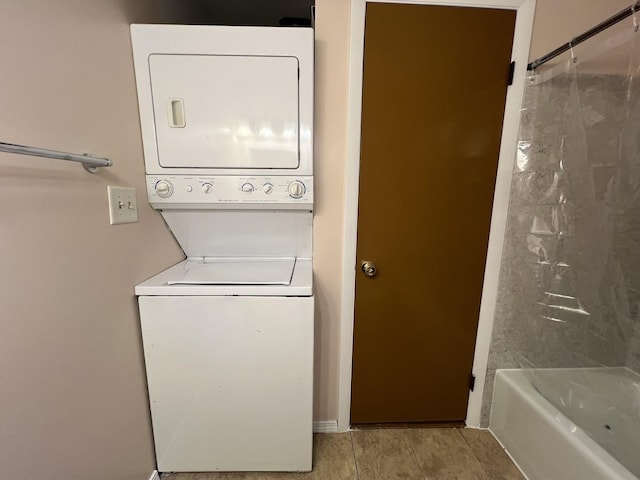 washroom featuring stacked washer and clothes dryer