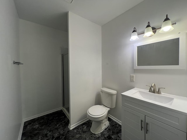 bathroom featuring vanity, a shower with door, and toilet