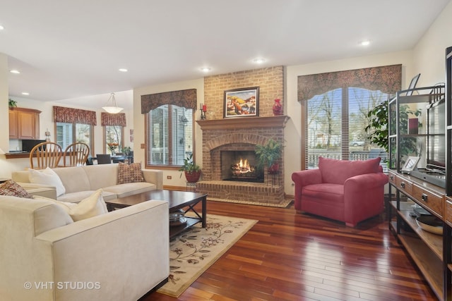 living room with dark wood-type flooring and a fireplace