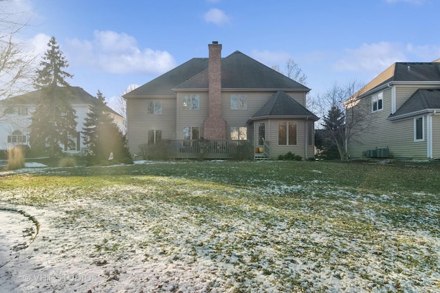 rear view of property featuring a wooden deck, a lawn, and cooling unit