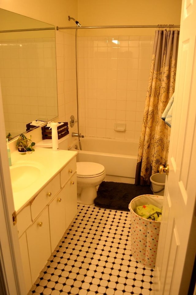 bathroom with toilet, tile patterned floors, vanity, and shower / bath combo